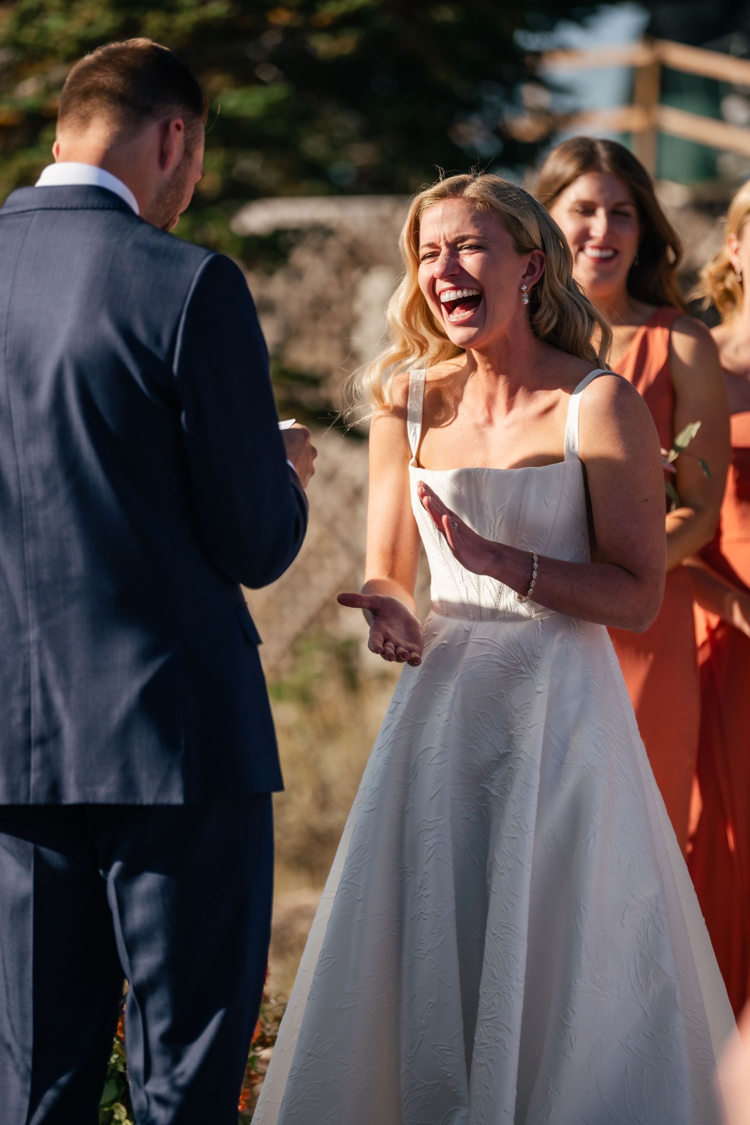 Candid outdoor wedding ceremony moments showing joyful reactions and laughter.