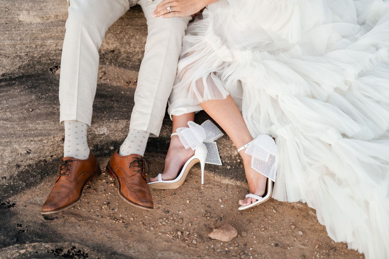 Zion destination. A series of wedding photos showing close-up details of bride and groom's feet in brown and white shoes on rustic ground.