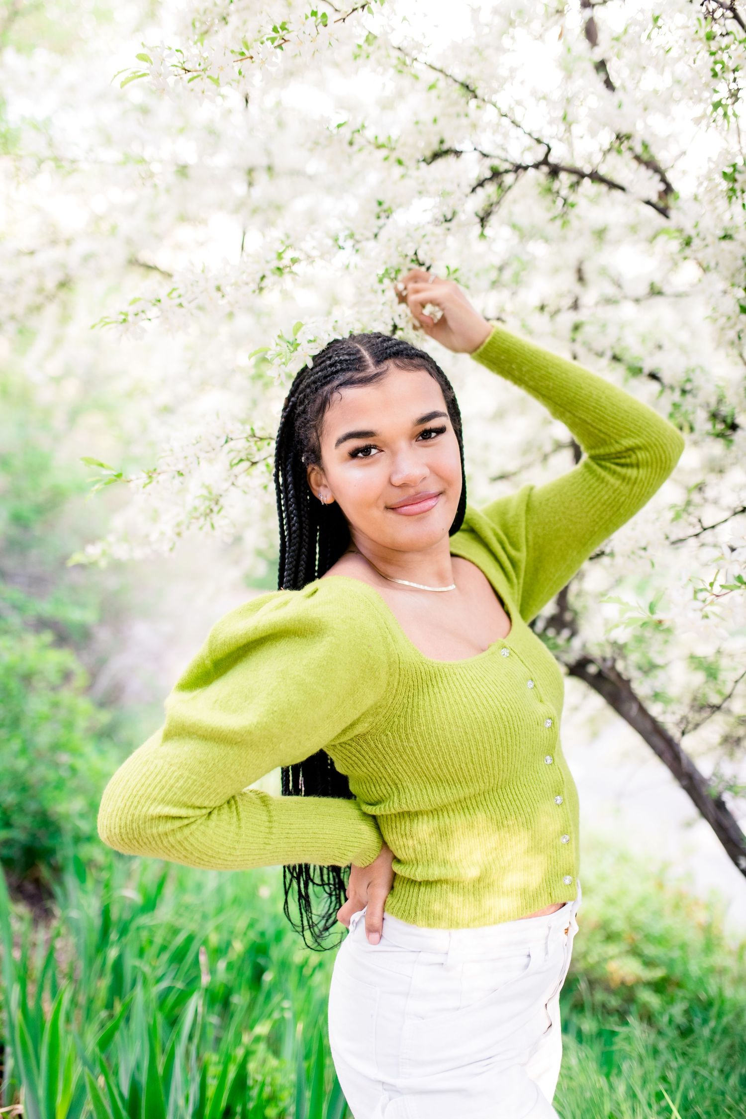 Outdoor photoshoot in a dreamy white cherry blossom orchard with bright lime green accents.