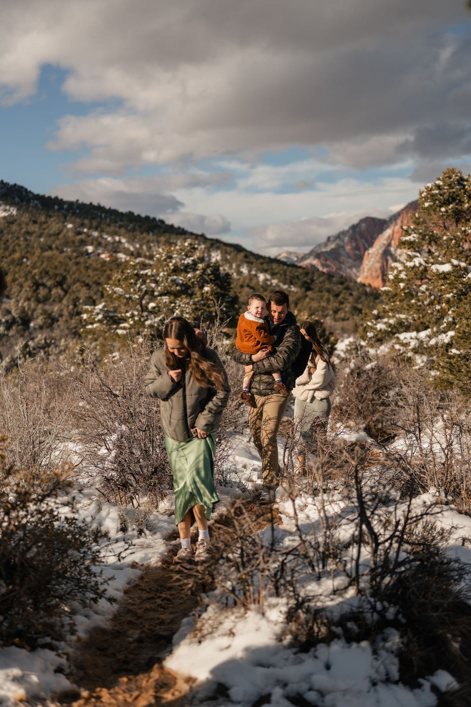 Group of photographers capturing moments in a snowy mountain landscape.
