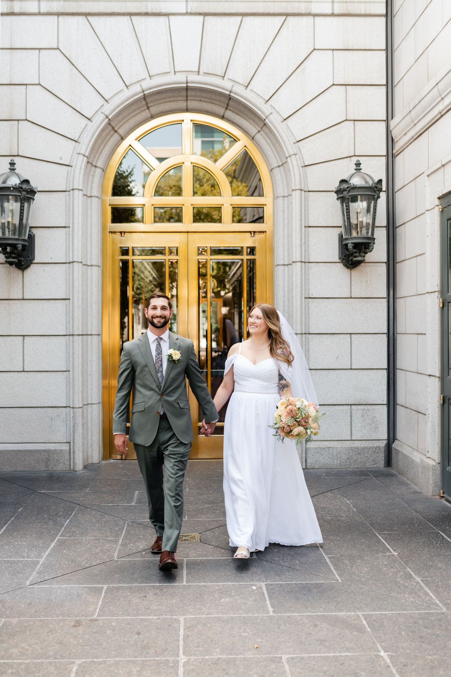 Series of wedding photos showing a couple walking through an elegant arched entrance with stone architecture.