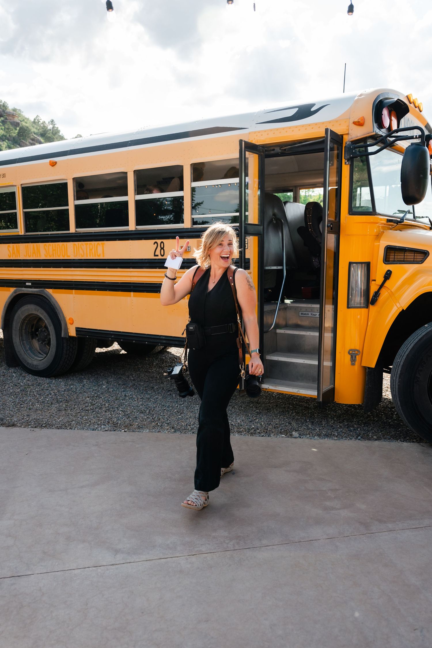A black dress contrasts against yellow school buses in a creative wedding photo sequence.