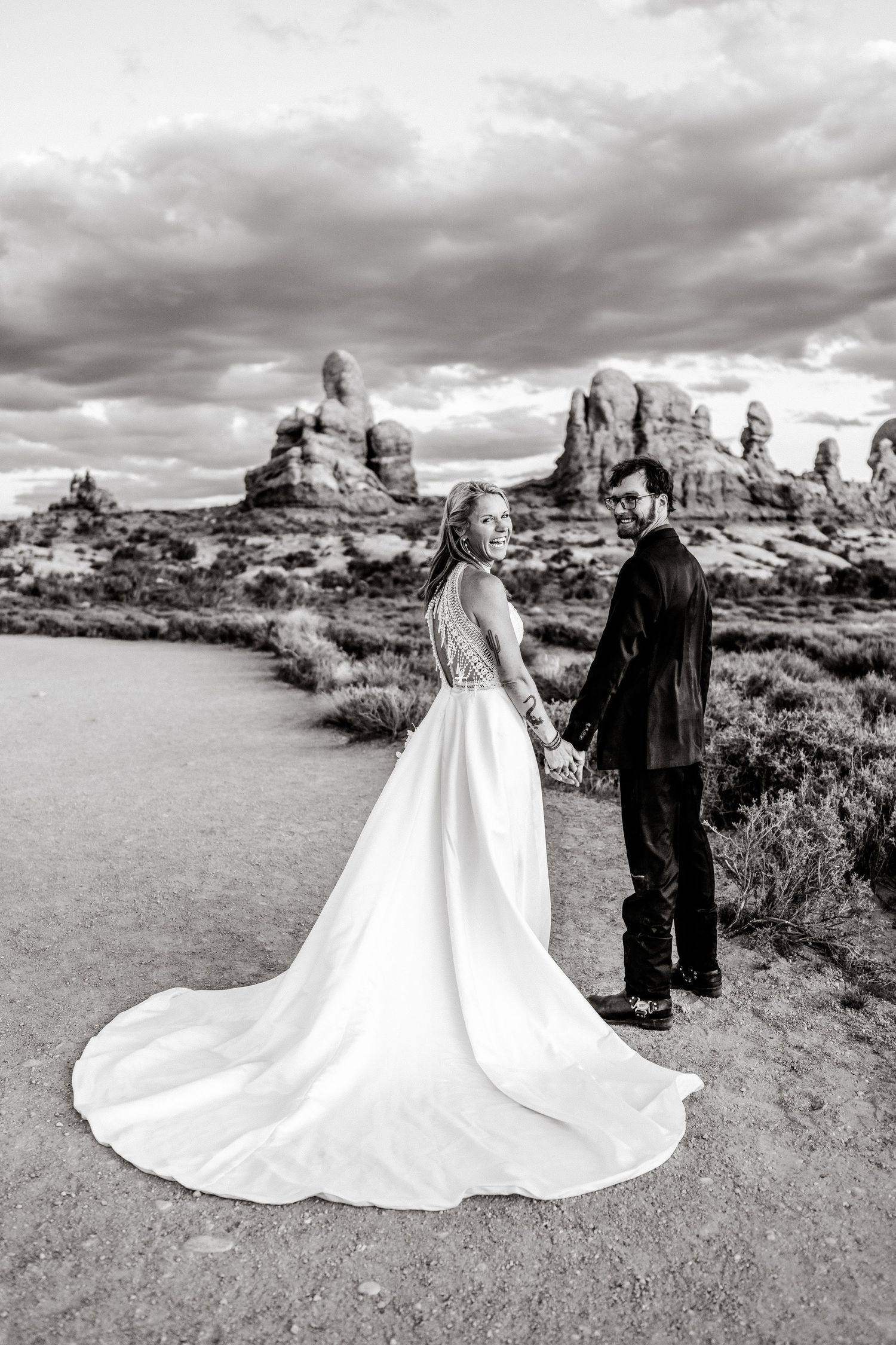 Elopement couple laughs during their wedding photos session in Arches National Park