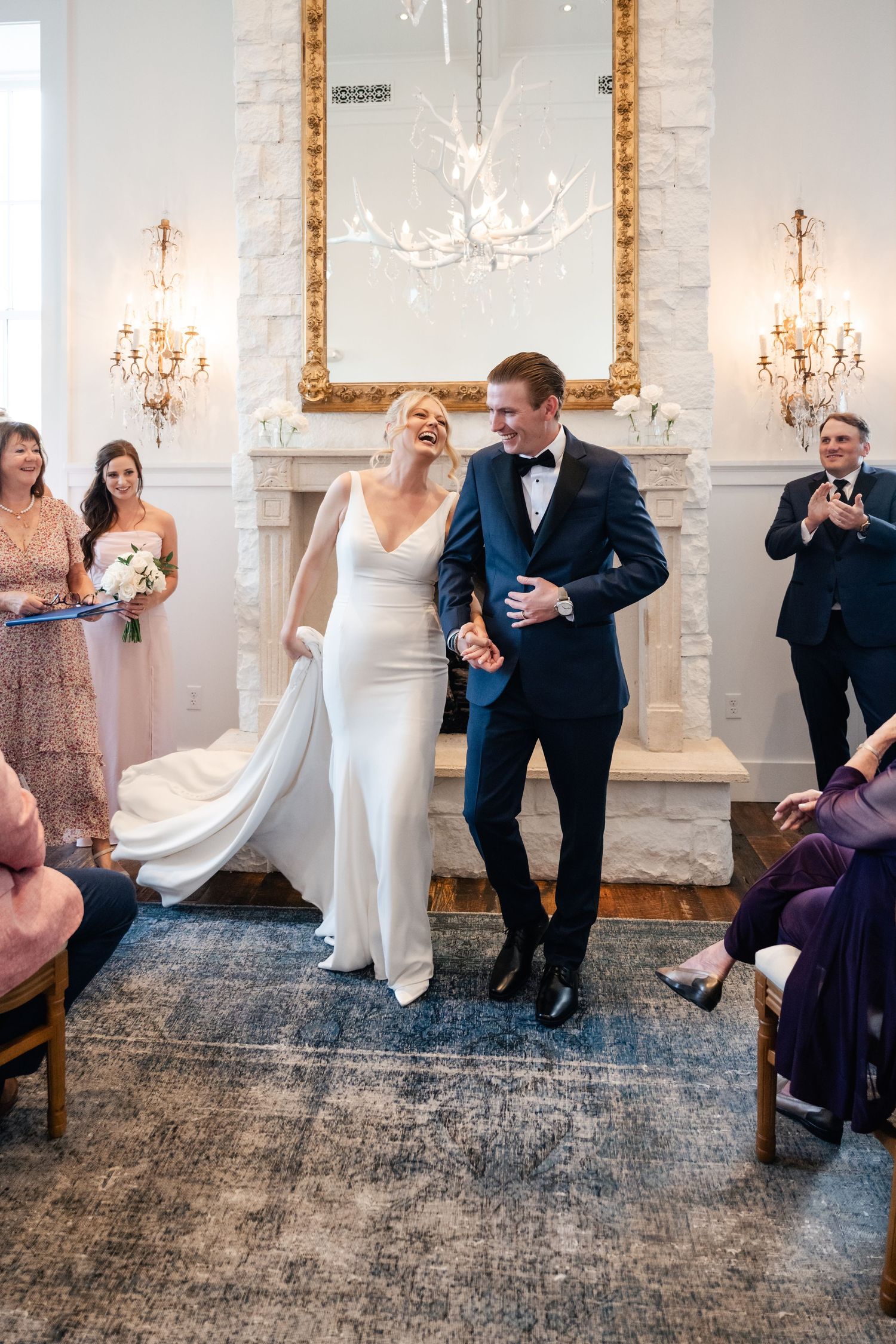 Wedding sequence showing playful dance moves between a couple in a white-walled venue with vintage decor.