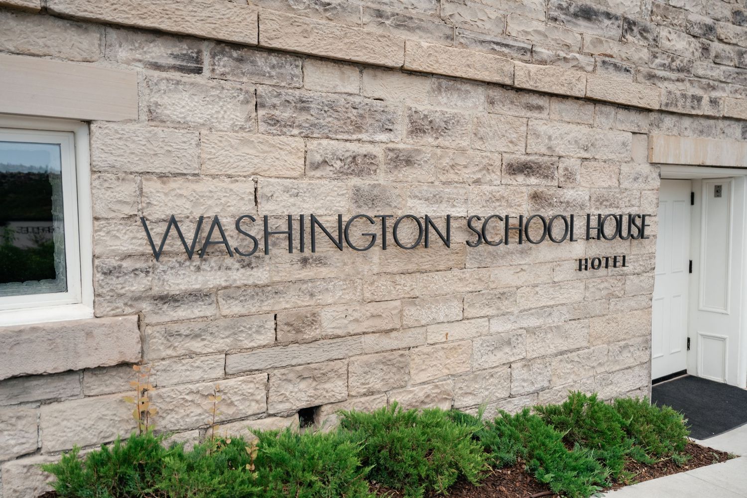 Close-up of stone facade showing 'Washington School Lodge' signage on the building exterior.
