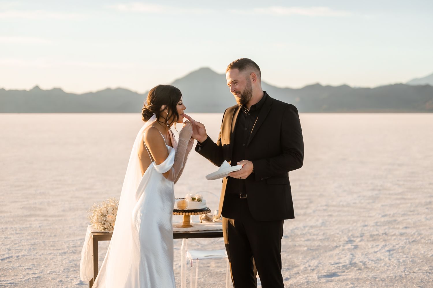 Wedding couple enjoying celebratory moment on scenic salt flats.