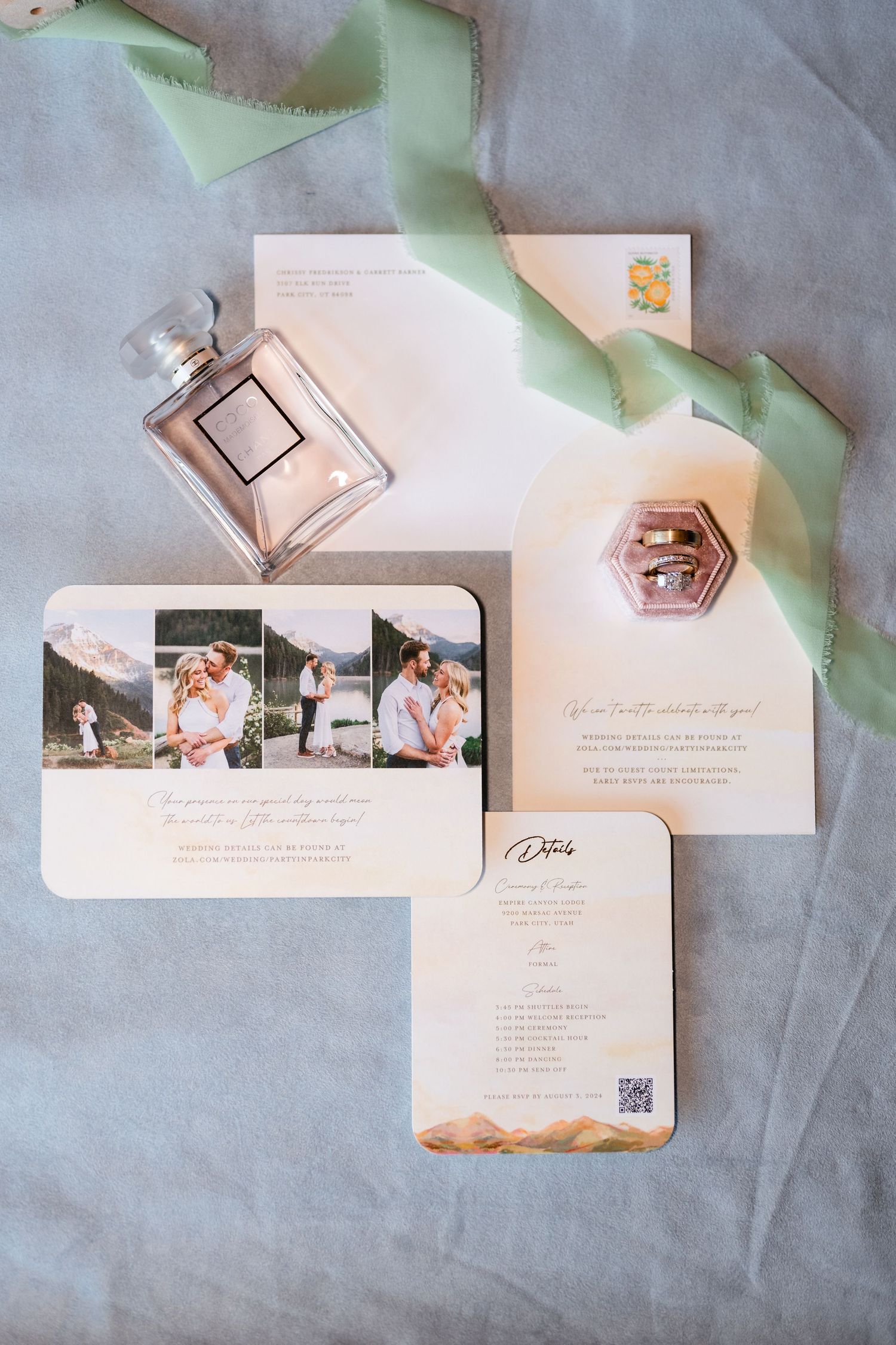 Elegant wedding invitations with photos displayed on soft gray background with mint ribbon accents.
