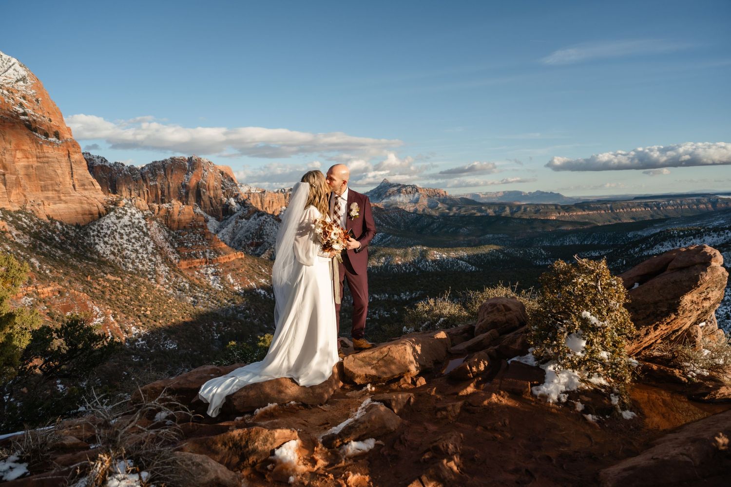 Dramatic sunset view of red rock cliffs and desert landscape in Zion National Park.