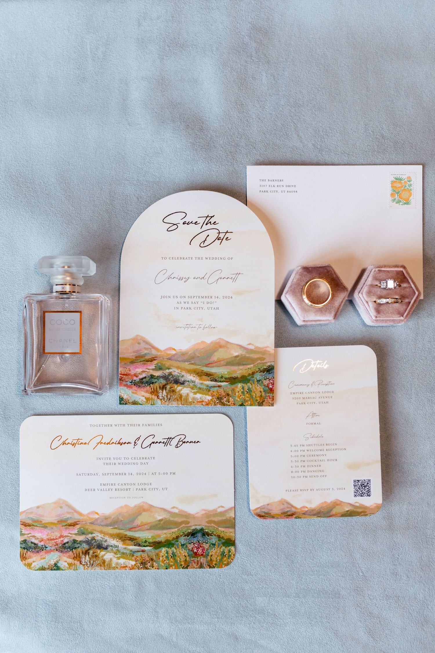 Wedding stationery suite featuring watercolor mountain landscapes and rose gold accents.