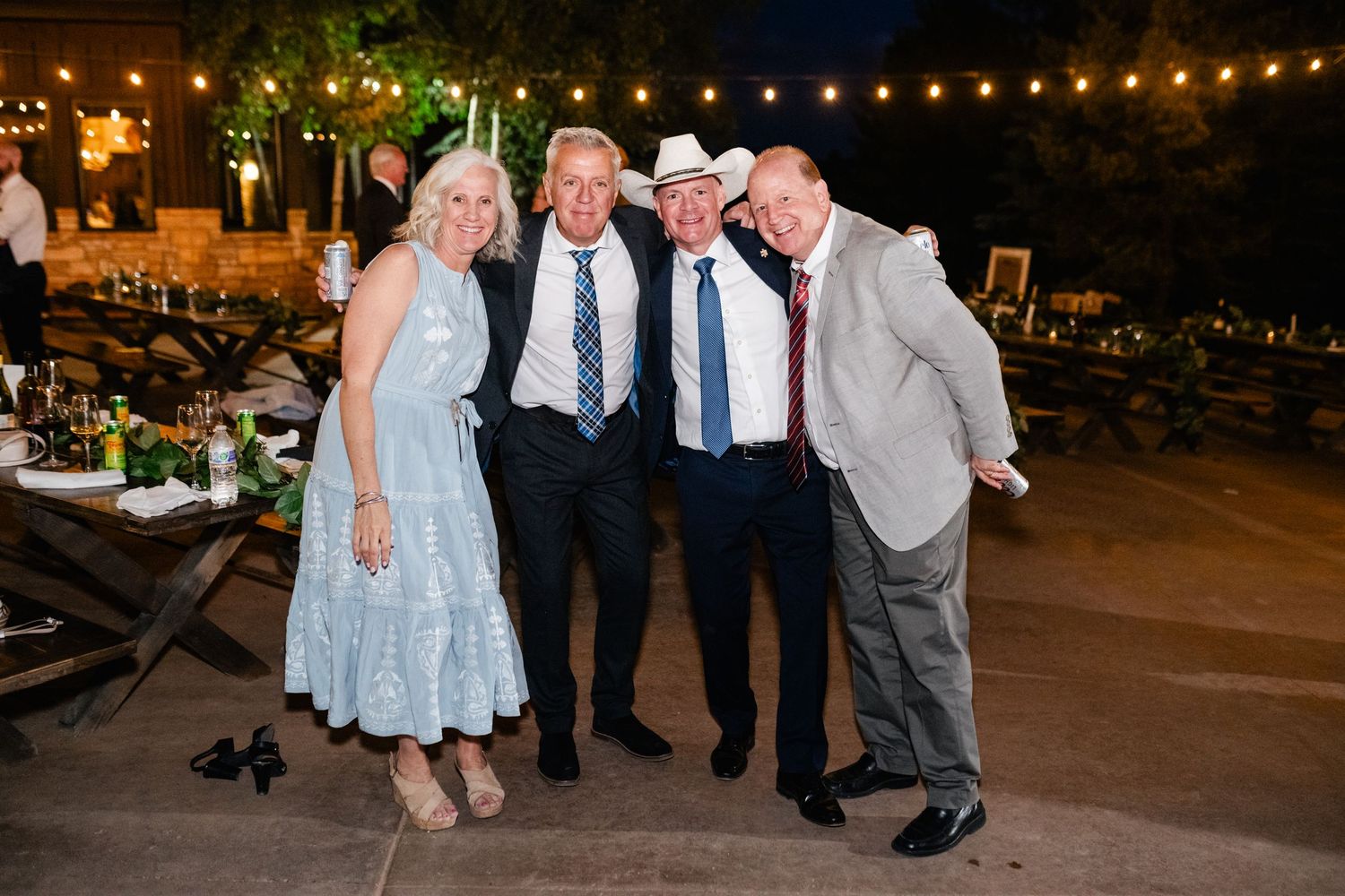 Wedding guests posing together during evening reception celebrations.