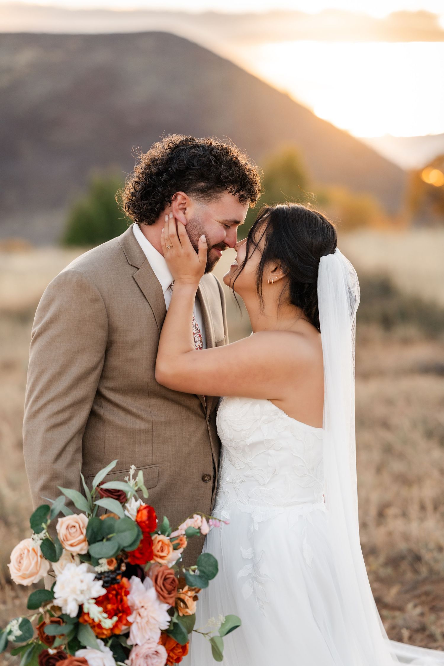 An intimate wedding portrait series with a floral bouquet against desert mountains.