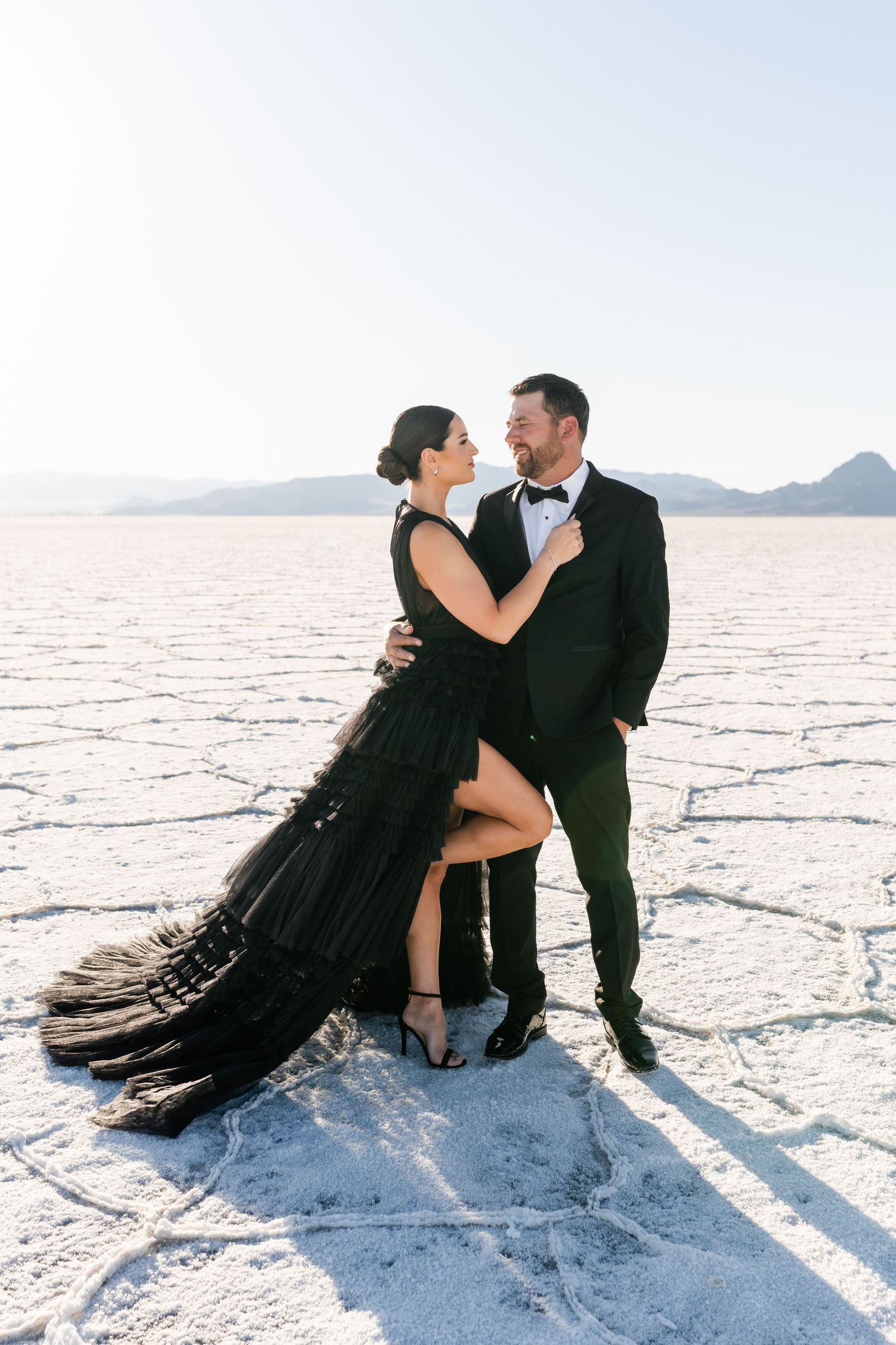 Salt Flats Photographer. A couple in formal wear poses intimately on the bright white salt flats.