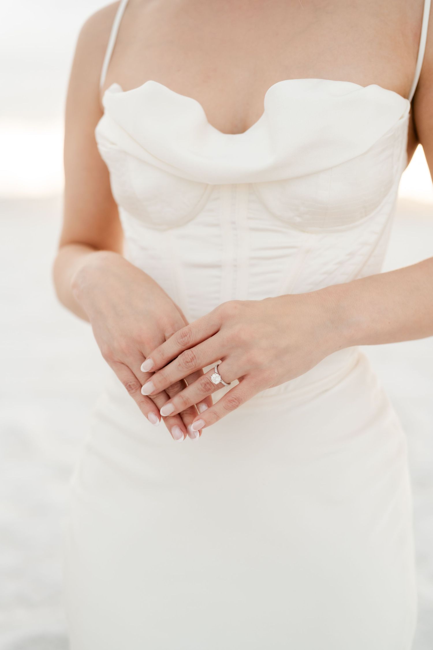 Salt Flats Elopement Photographer. Close-up details of a white wedding dress and engagement ring against a light background.