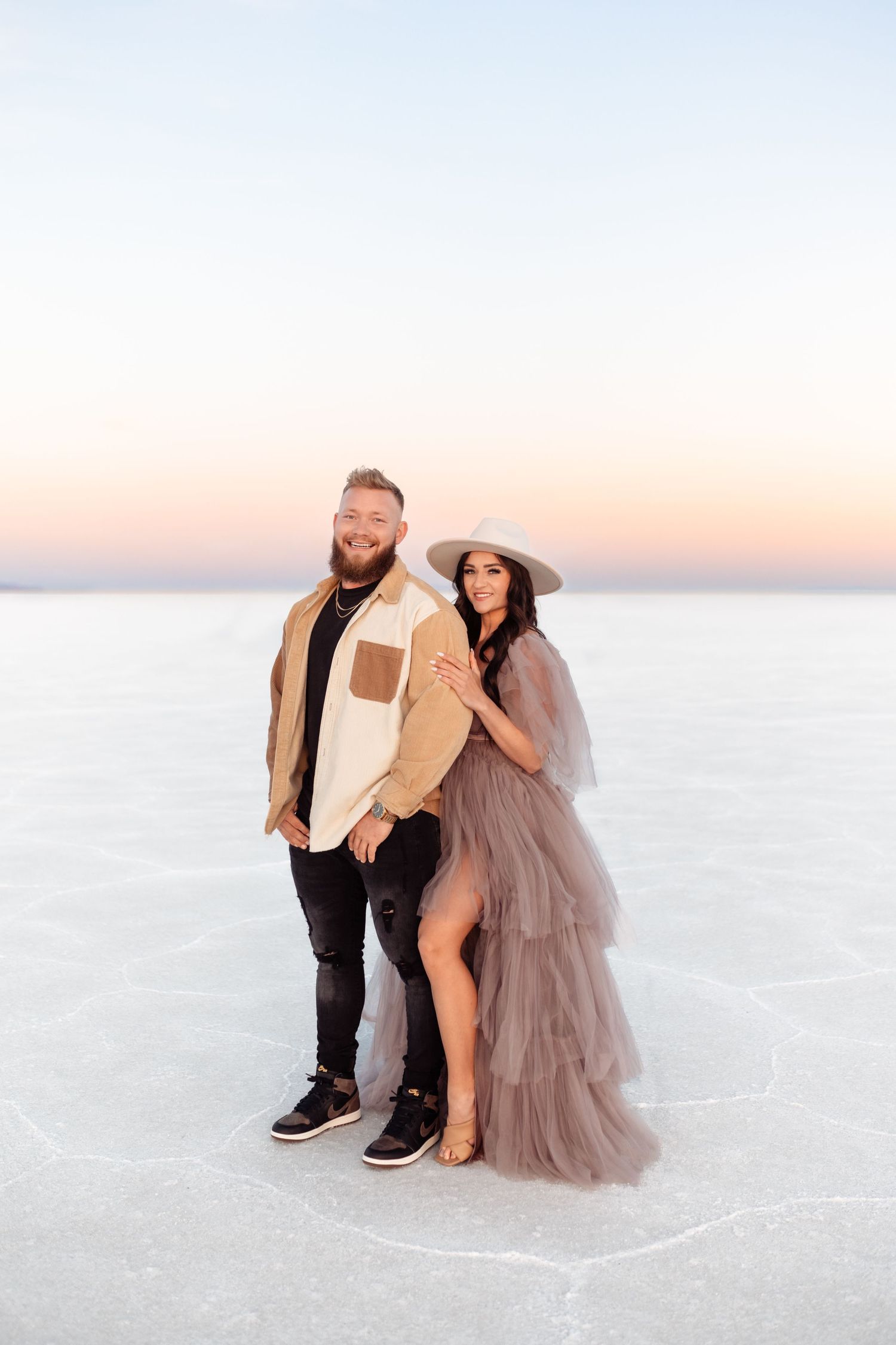 Couple hold each other during Salt Flats photos by Utah couples photographer during sunset