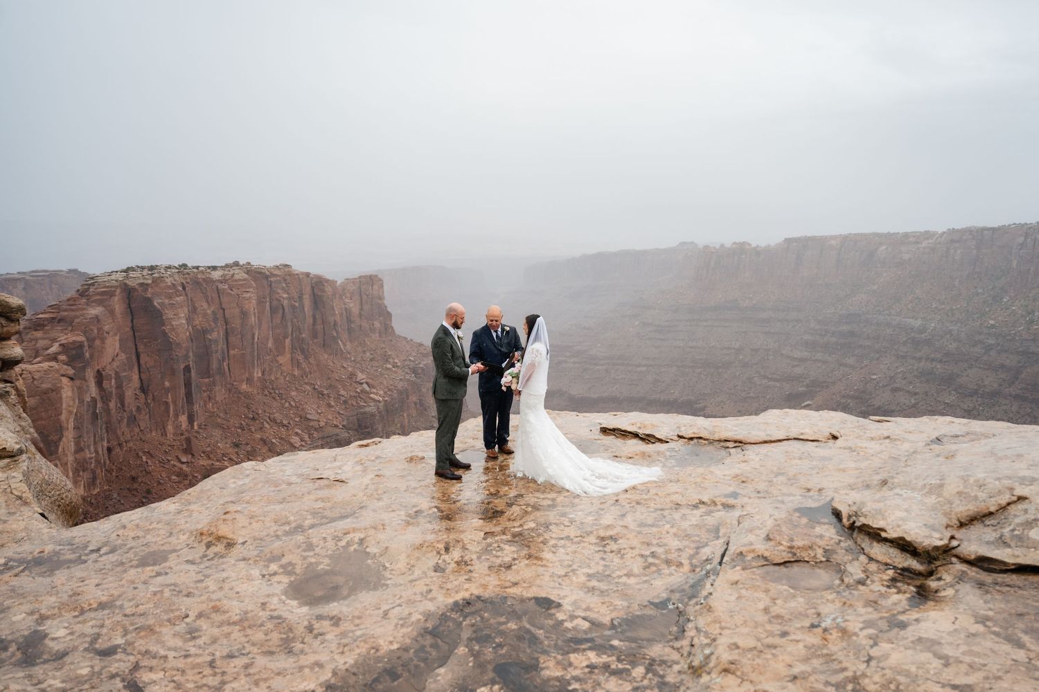 Intimate wedding ceremony takes place on dramatic canyon overlook.