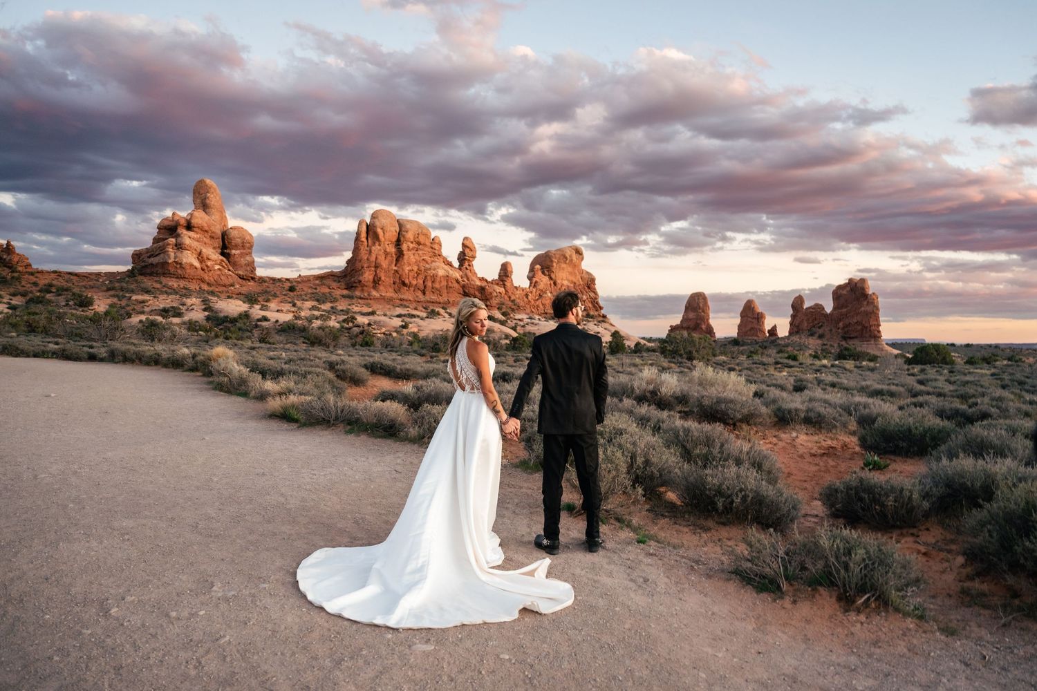 Elopement couple pose for editorial photo in Arches National Park by Utah Elopement Photographer and videographer