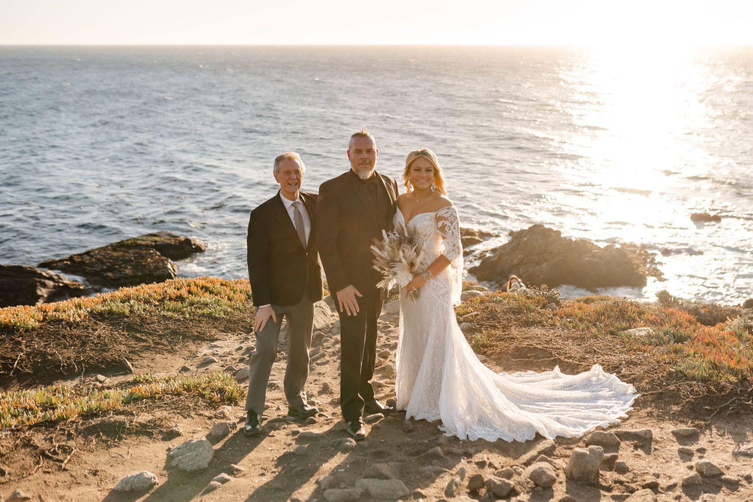 Golden hour wedding photos captured along scenic coastline with rocky outcroppings.