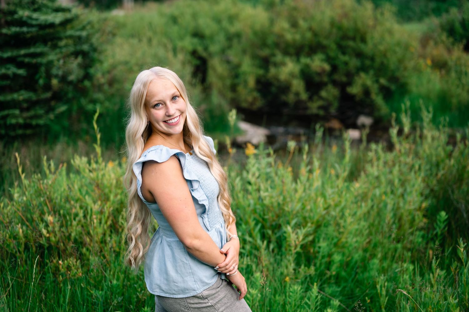 over the shoulder smiling portrait of a senior girl taken by Utah senior photographer