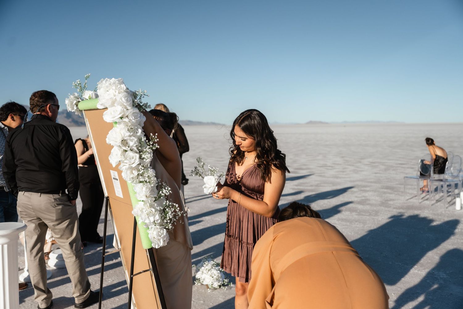 Wedding ceremony setup on the Bonneville Salt Flats with mountains in the background.