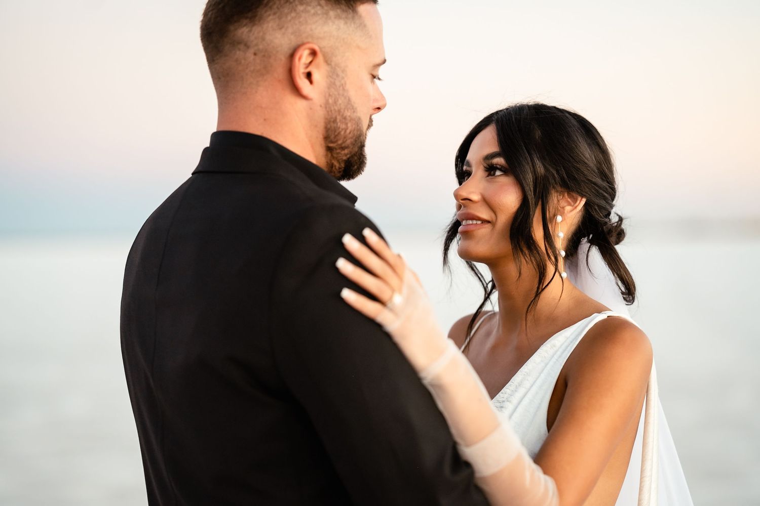 Intimate wedding couple portraits against soft natural lighting.