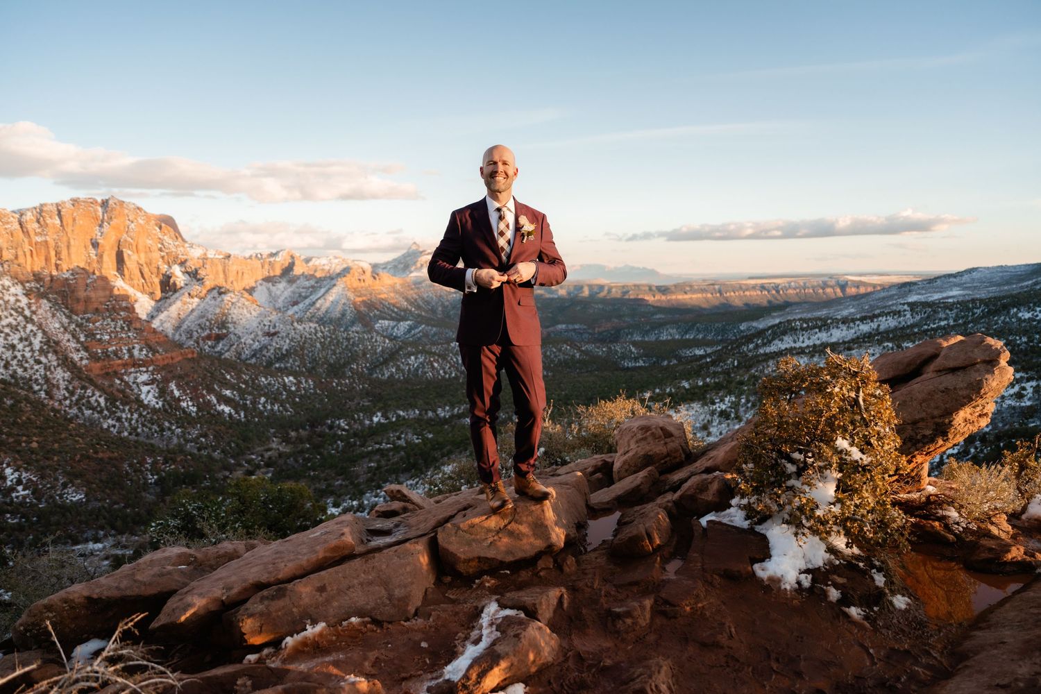 Scenic mountain wedding photography with dramatic red rock formations and winter landscape.