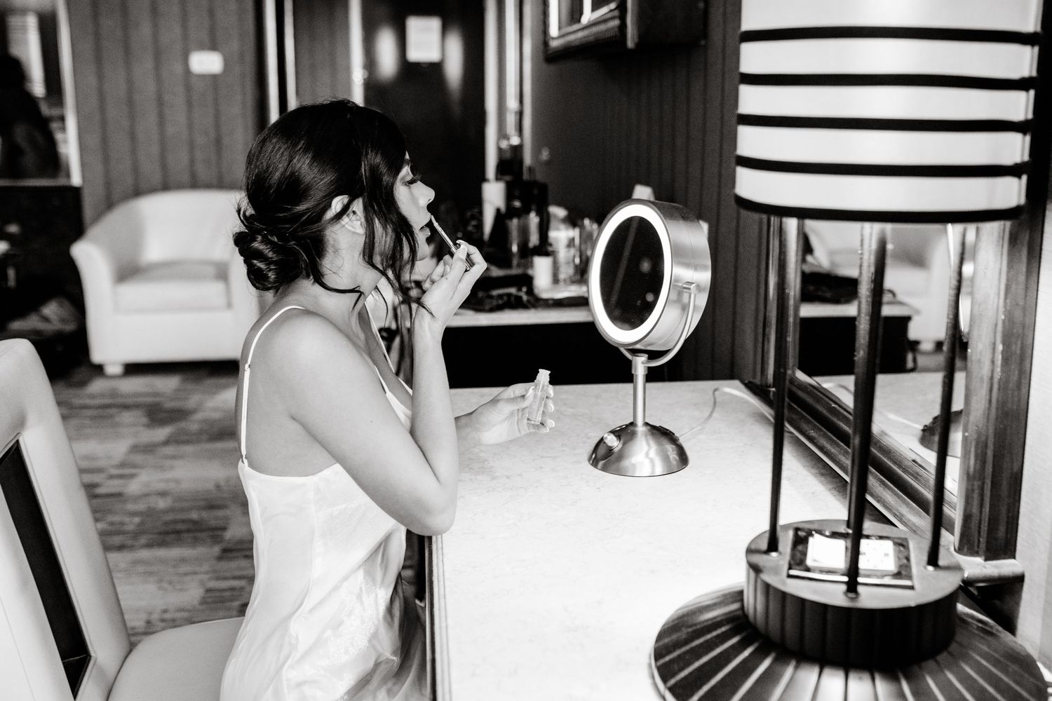 A collage of black and white wedding preparation moments showing details of dresses and decor.