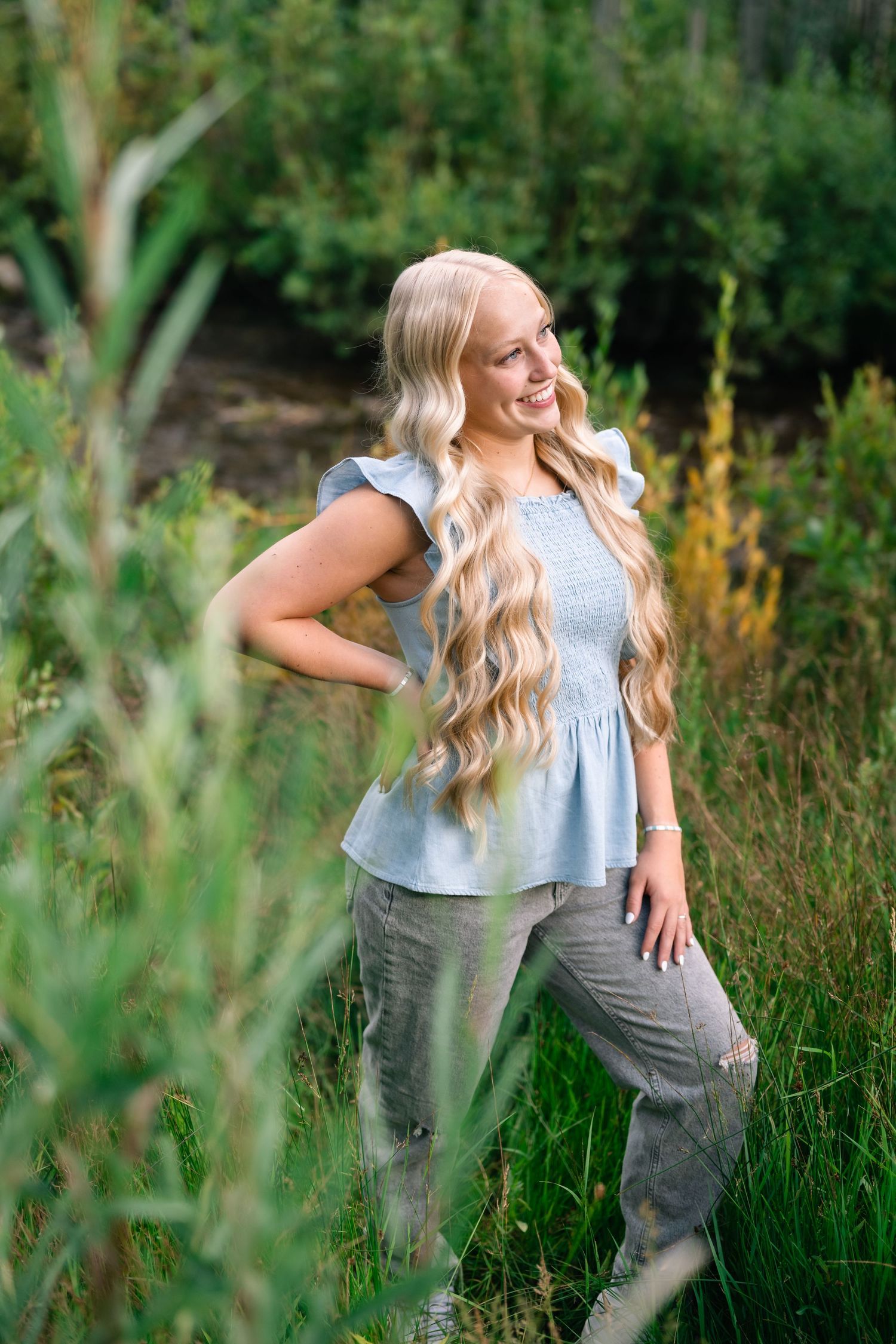 senior girl smiling into the sunset during her mountain senior session