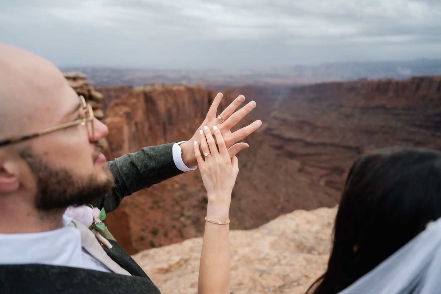 A person takes a panoramic photo of the vast desert canyon landscape at Dead Horse Point State Park in Utah.