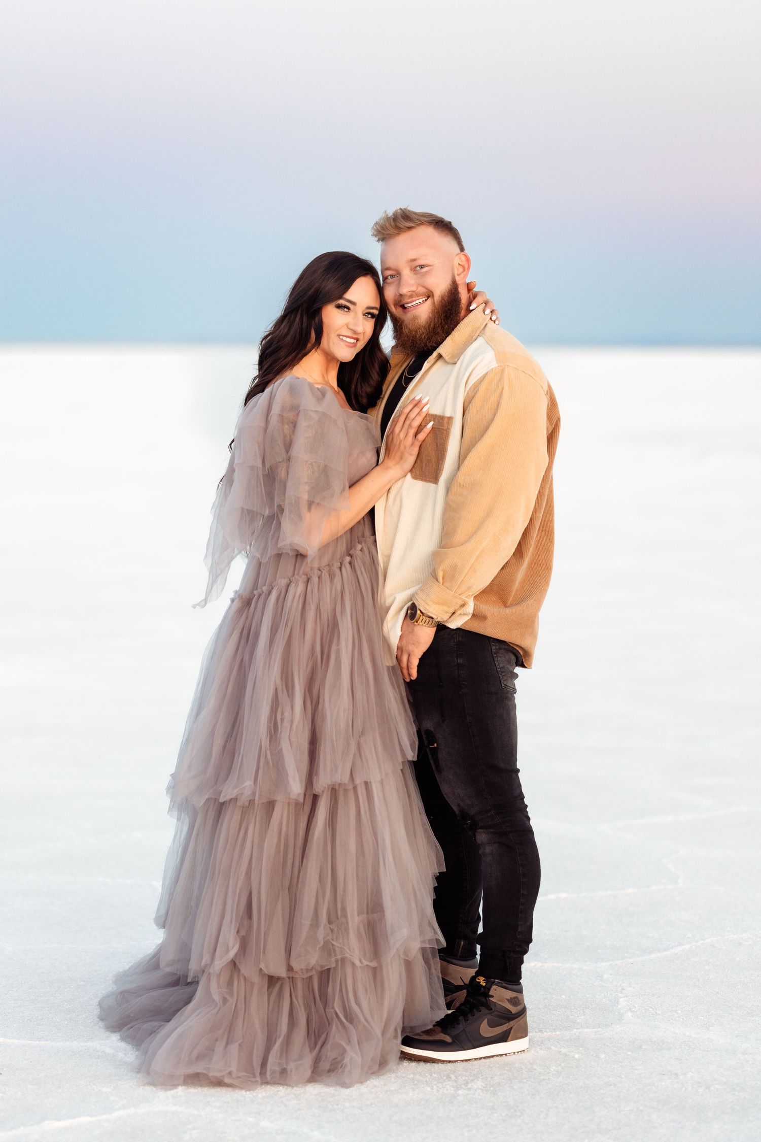Couple hold each other during Salt Flats photos by Utah couples photographer during sunset