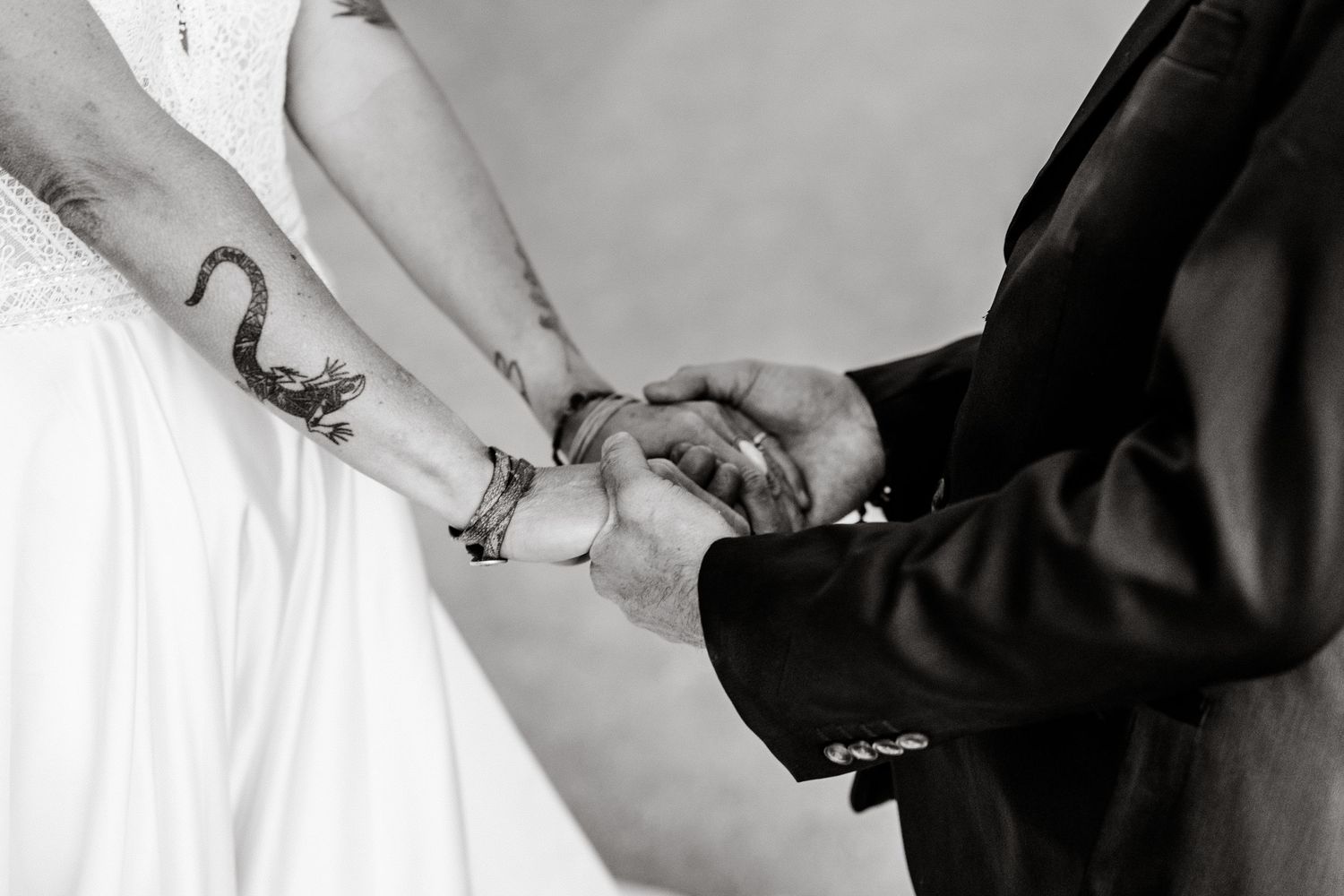 Elopement couple hold hands in Arches National Park by Utah Elopement Photographer and videographer