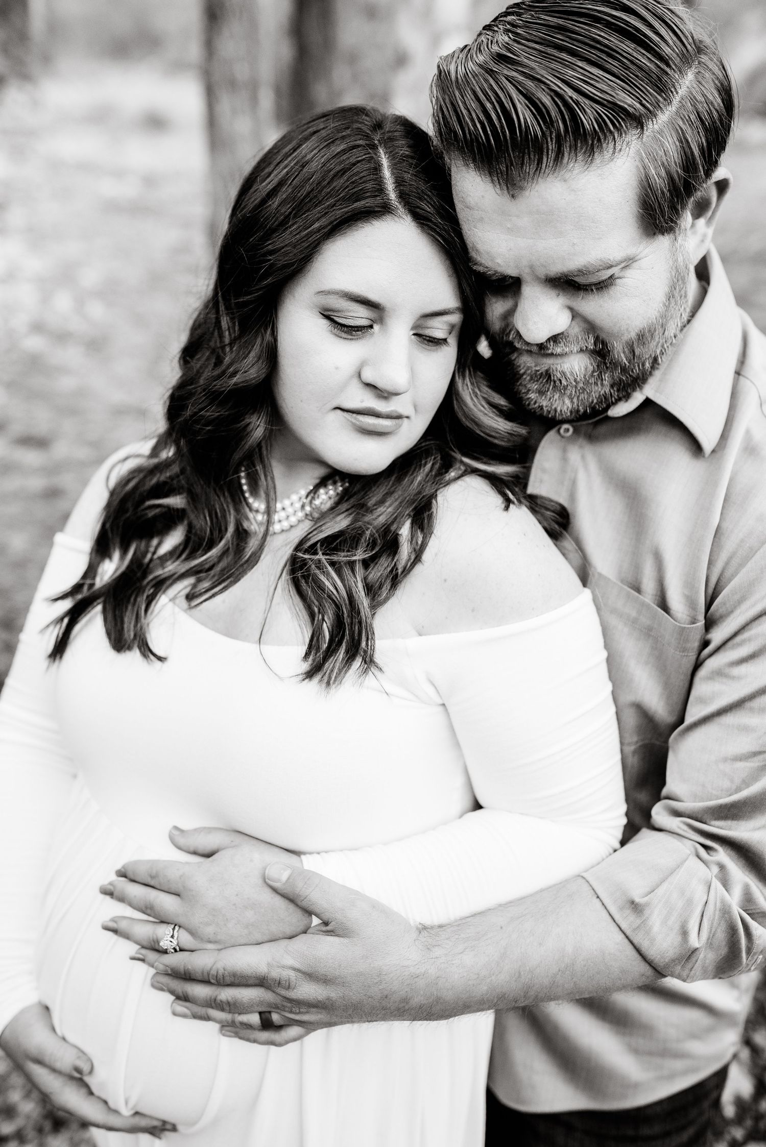 A romantic black and white photo series showing tender moments between a couple in an intimate embrace.
