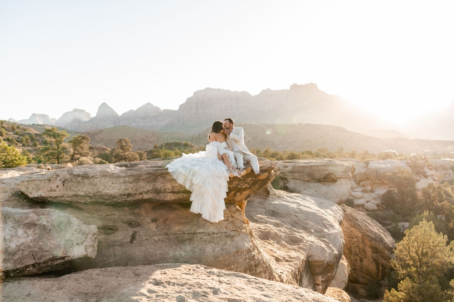 Zion Adventure Session. Golden hour wedding photography in a dramatic desert landscape with towering red cliffs.