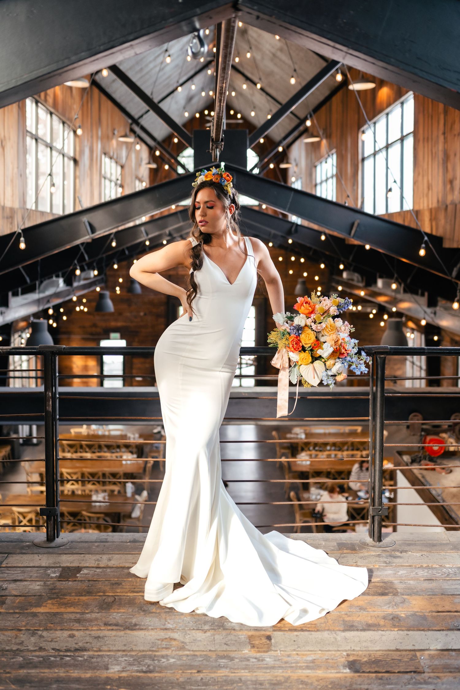 Elegant wedding photos in a rustic industrial venue with string lights, wood floors, and black metal beams. Knot & Pine, wedding venue.