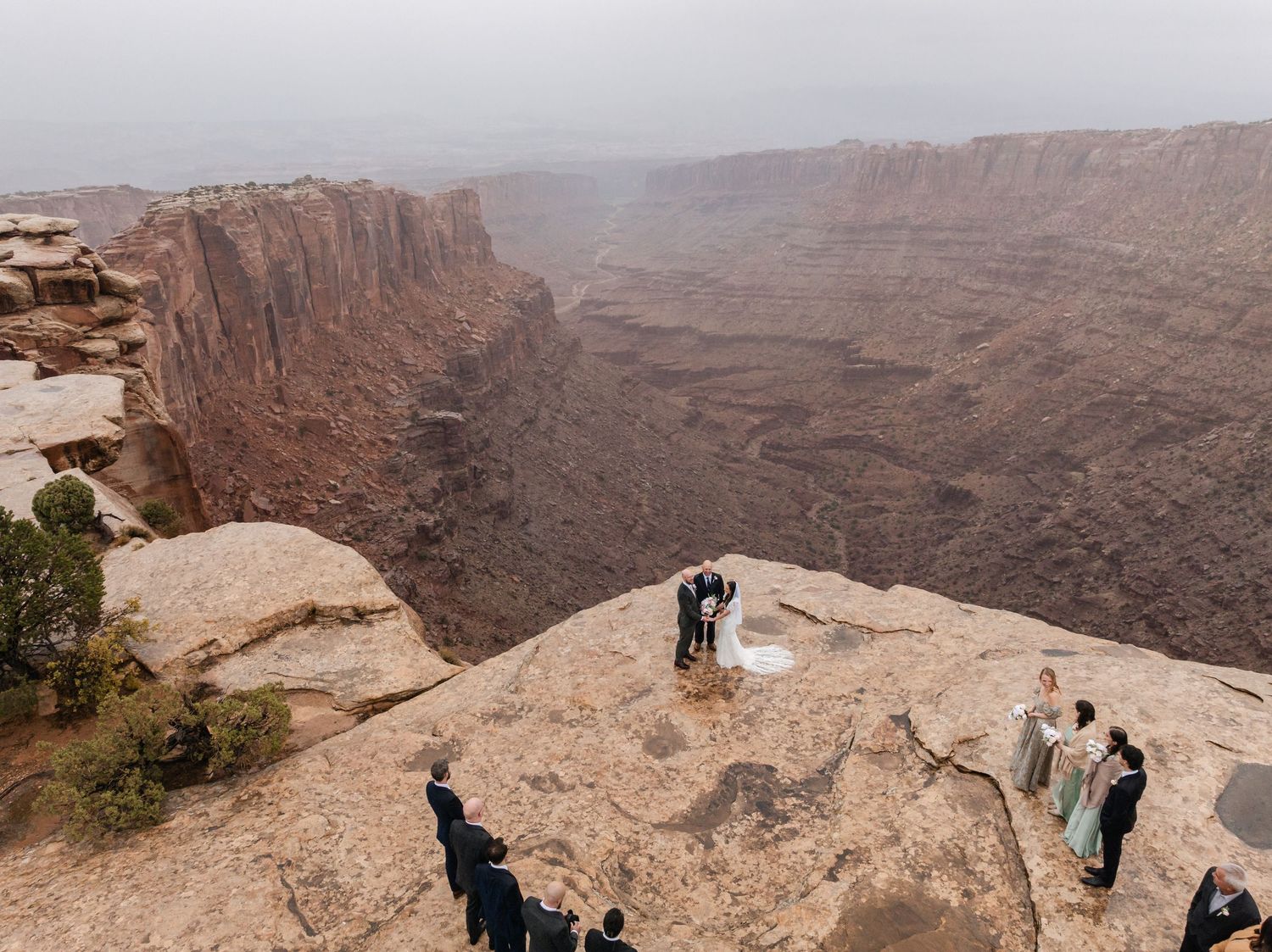 Panoramic series of photos showing visitors enjoying scenic viewpoints along the rim of a vast desert canyon landscape.