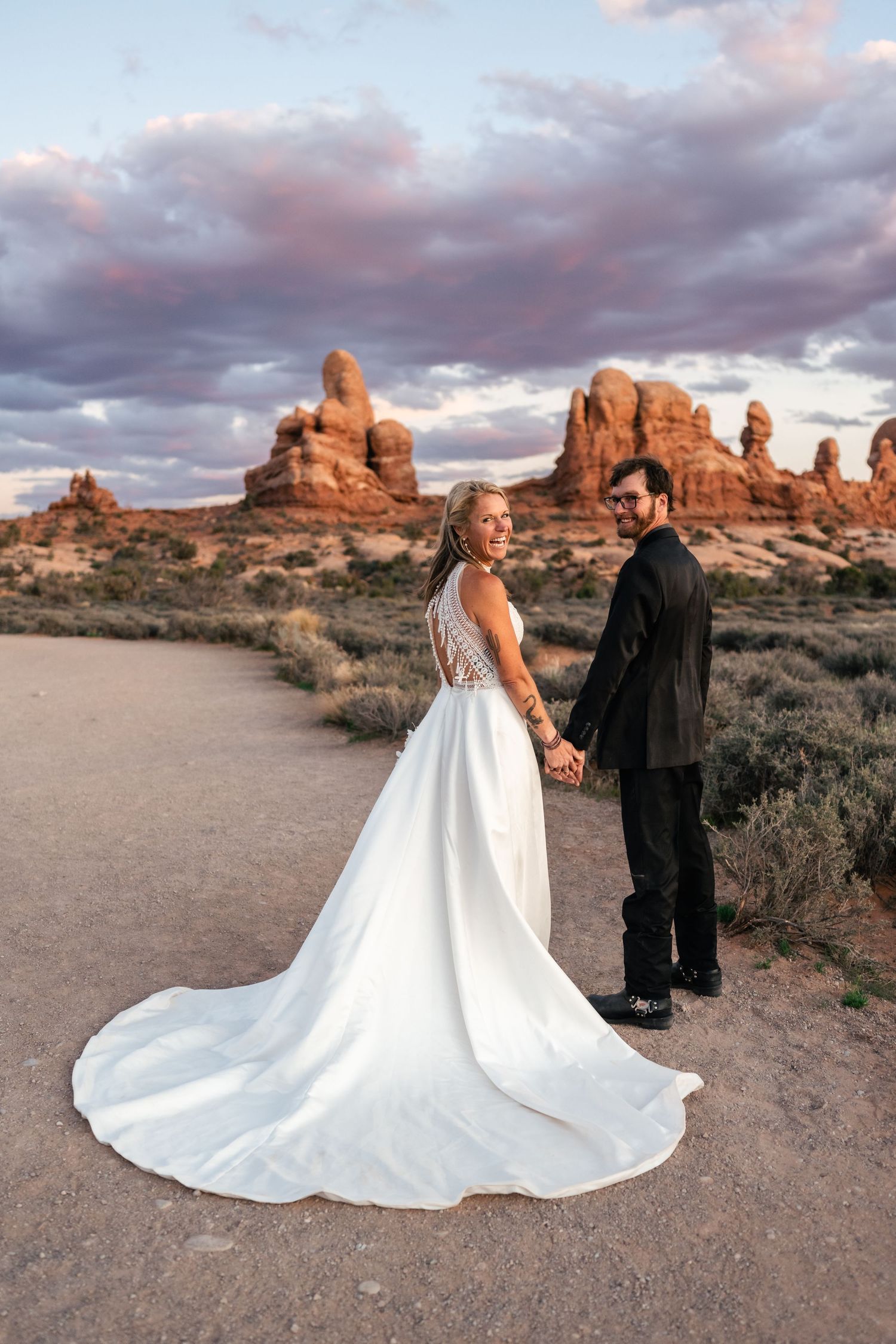 Elopement couple laughs during their wedding photos session in Arches National Park