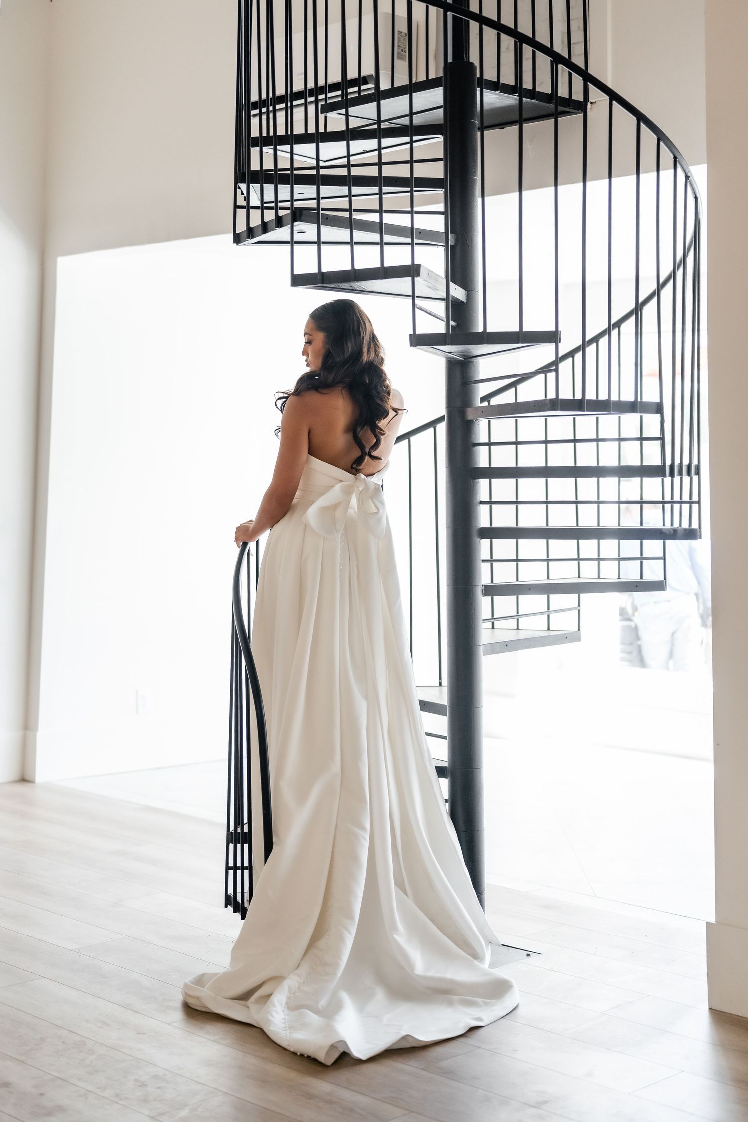 Bride on a spiral staircase at Moments on Main venue by Utah Wedding Photographer and Videographer. Preferred Vendor. Utah Wedding Venue.