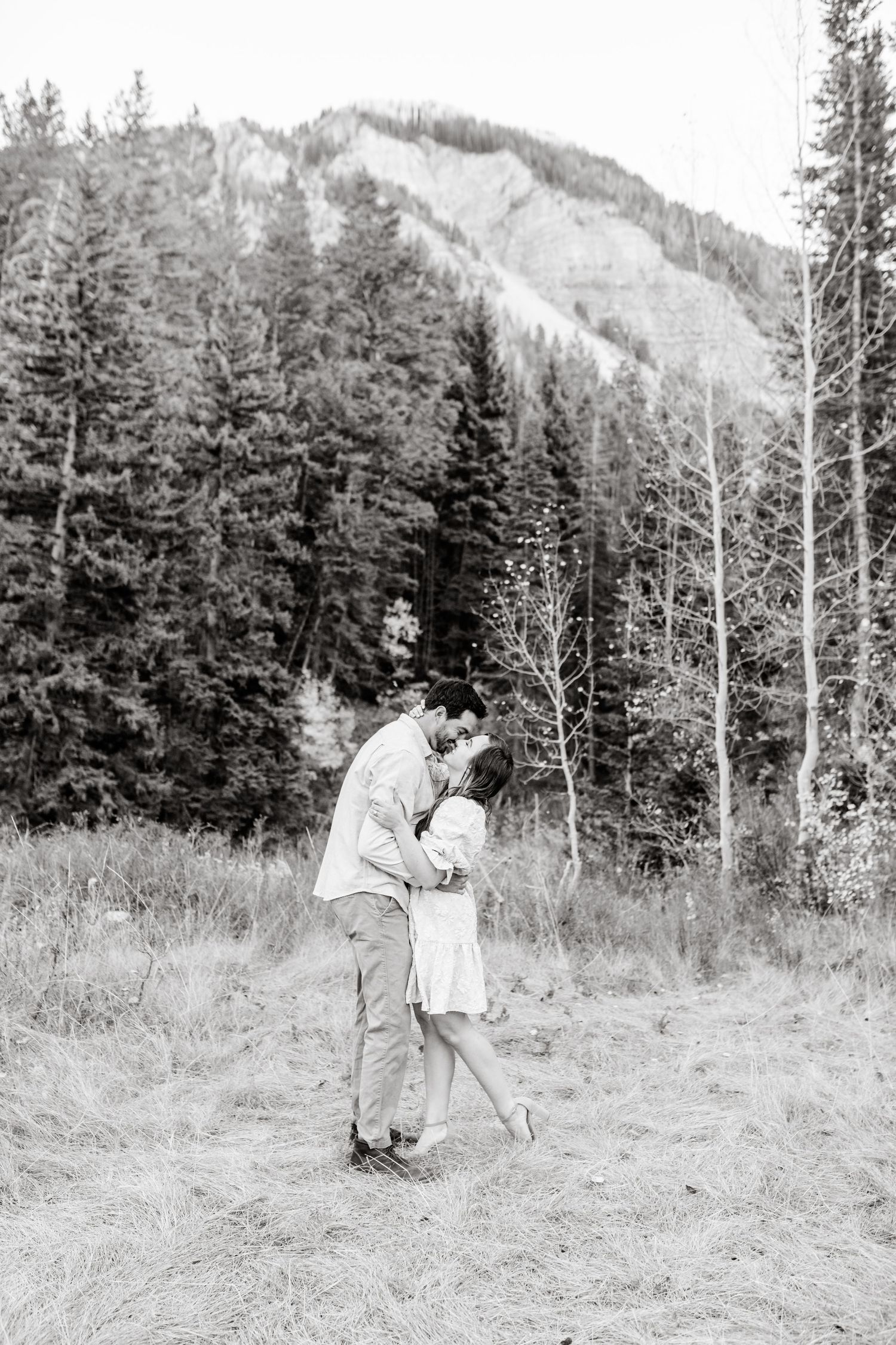 Husband and wife get portraits together young family has a close cuddle together during their fall family photos