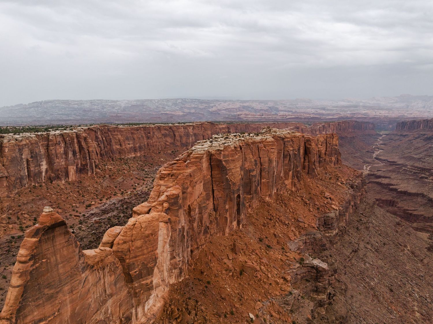 Panoramic view of red rock canyons and cliffs at Dead Horse Point State Park in Utah during sunset.