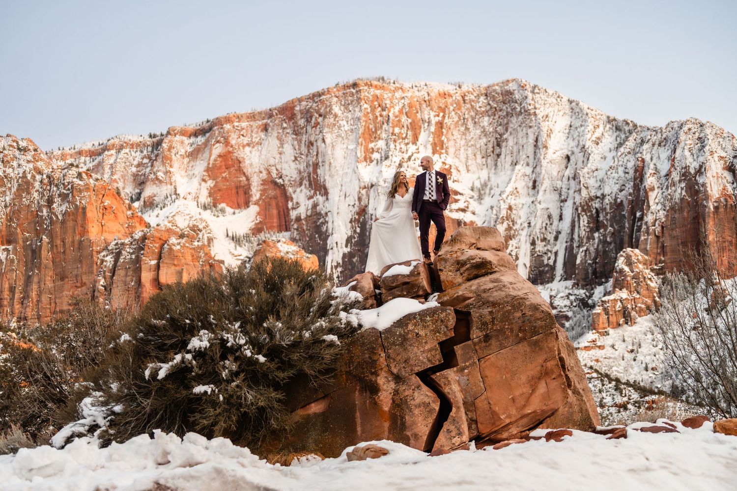 Sweeping winter vista of snow-covered red rock formations in Zion National Park.