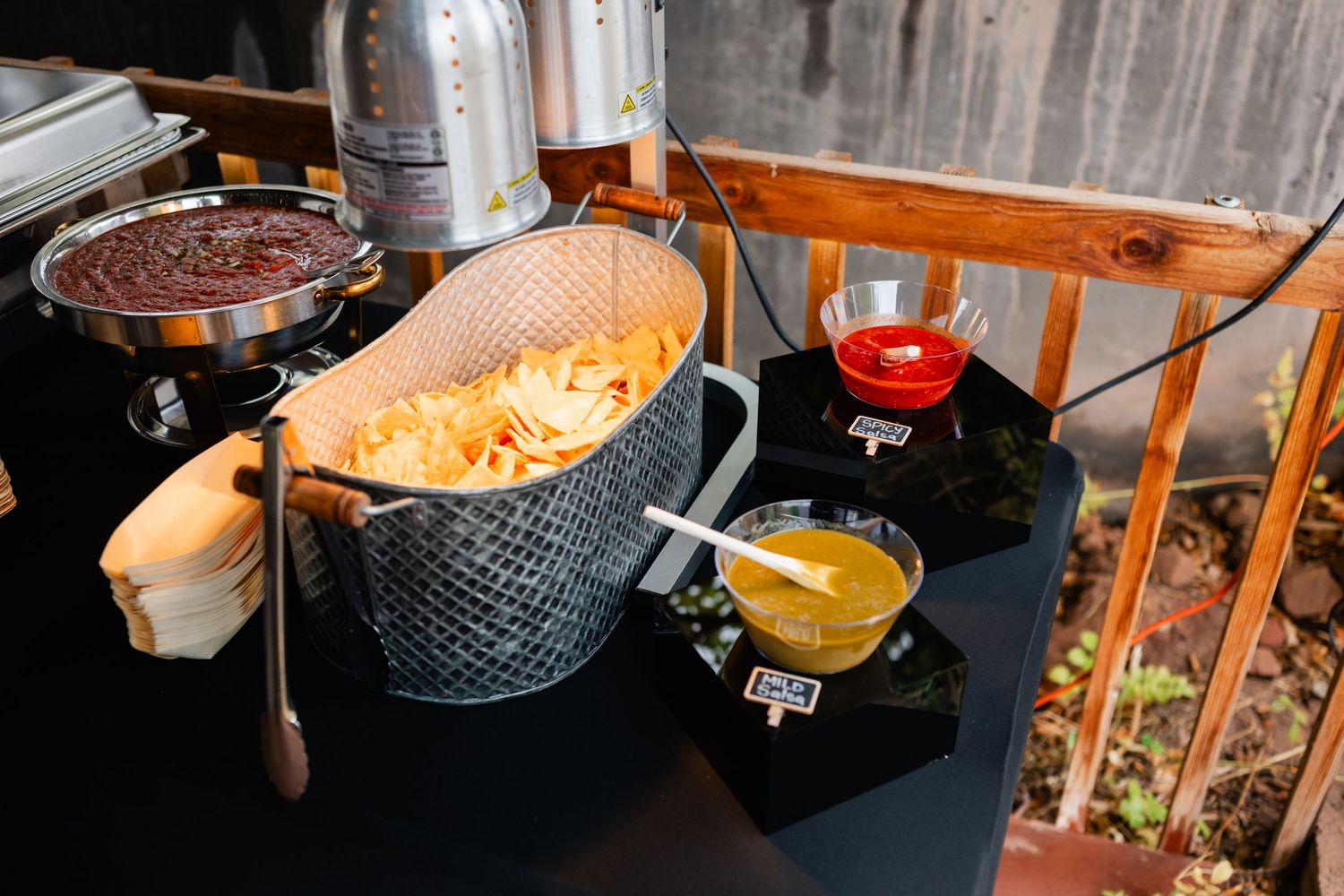 Catering staff serve colorful appetizers and drinks from elegant serving platters at an upscale event.