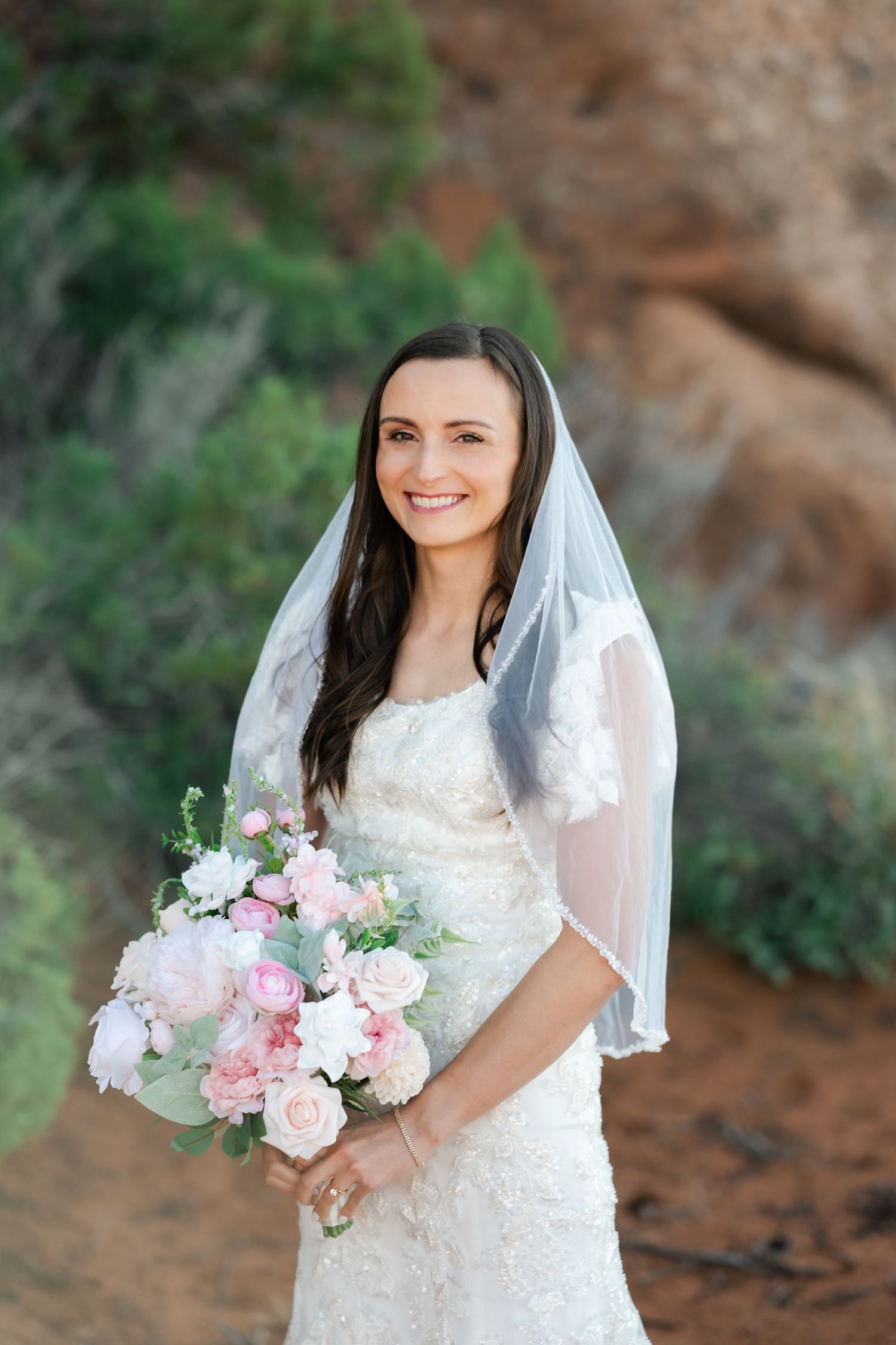 A wedding photo series showing a bride in a white lace dress holding a pink and white rose bouquet against a natural backdrop.