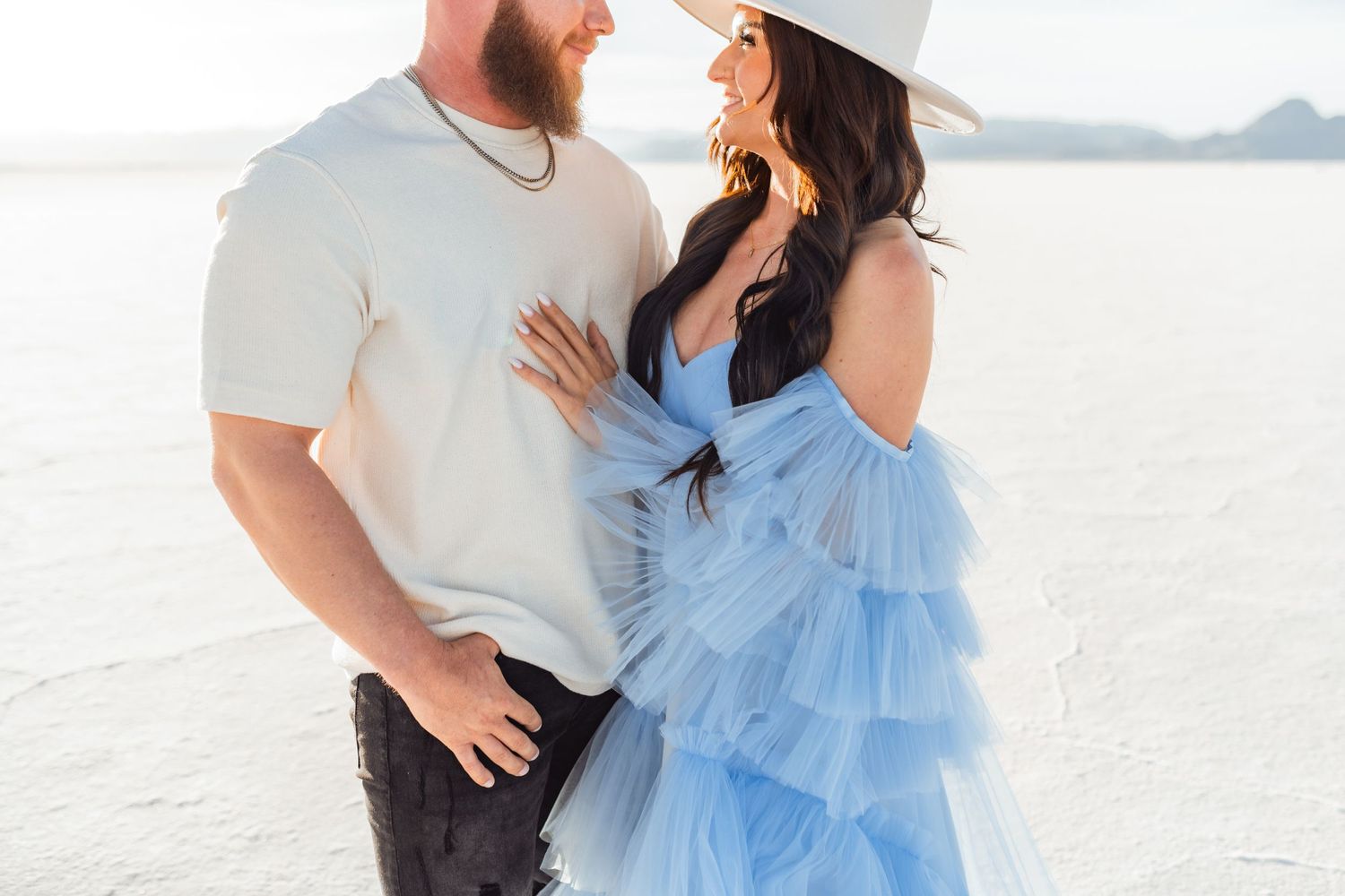 Couple hold each other during Salt Flats photos by Utah couples photographer during sunset