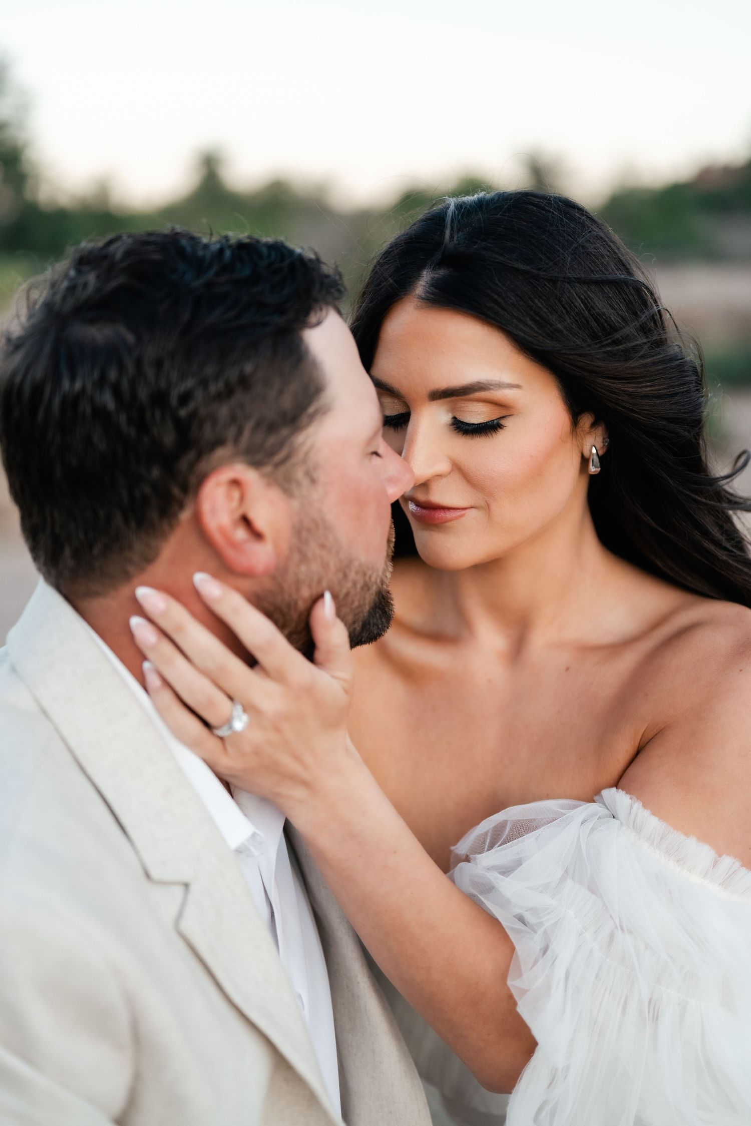 A tender intimate moment between newlyweds against a soft natural backdrop. Zion destination photographer.
