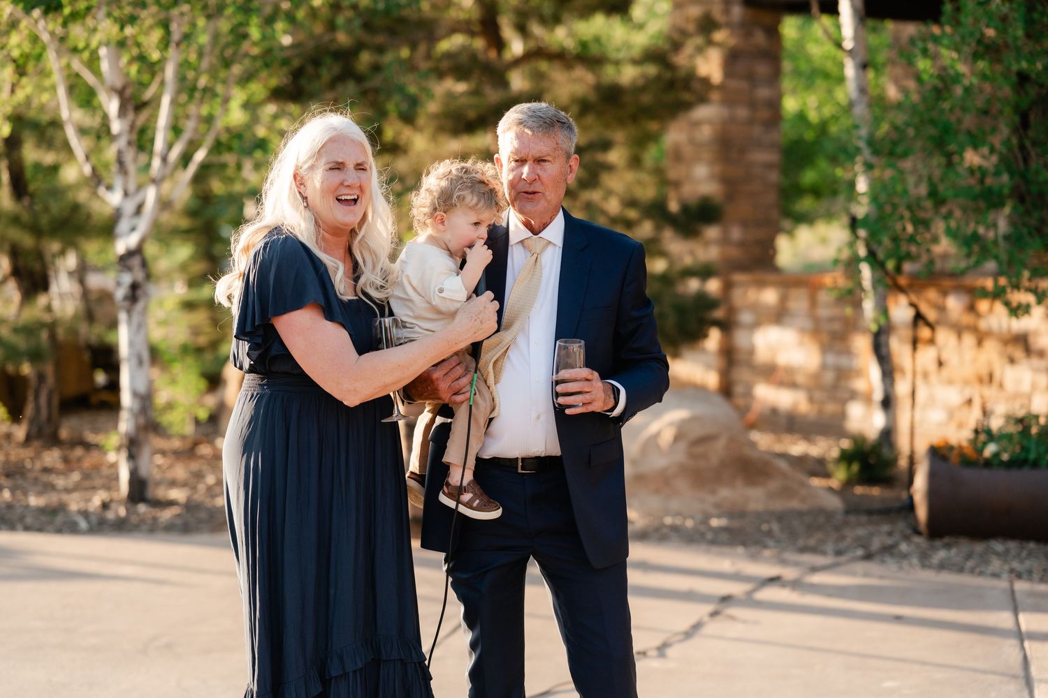 Couple shares a joyful moment during outdoor wedding celebration.