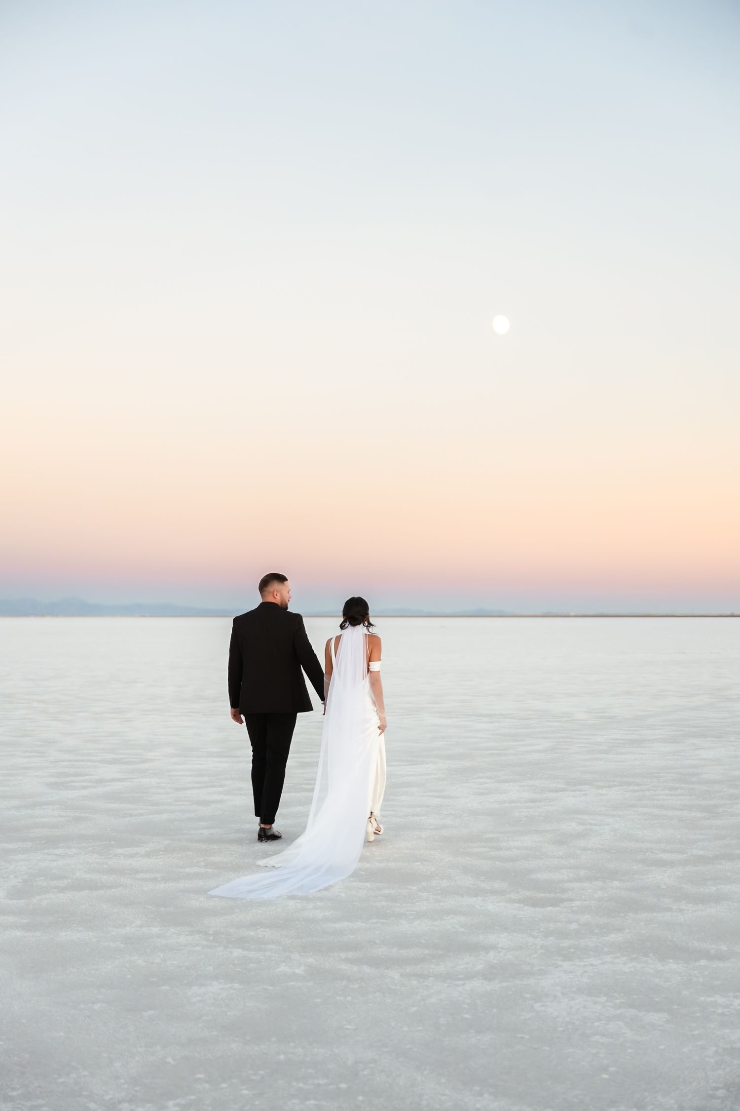 A romantic sunset photoshoot on the expansive white salt flats.