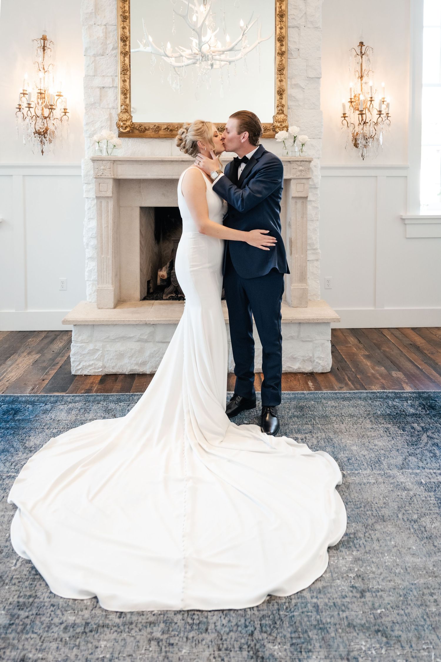 A couple shares a romantic dance in an elegant ballroom with crystal chandeliers and ornate decor.