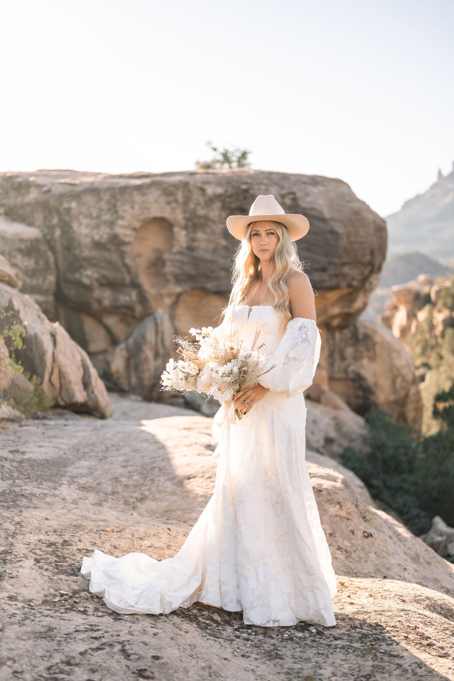 Utah elopement photographer captures desert sunrise bridal session with cowgirl hat
