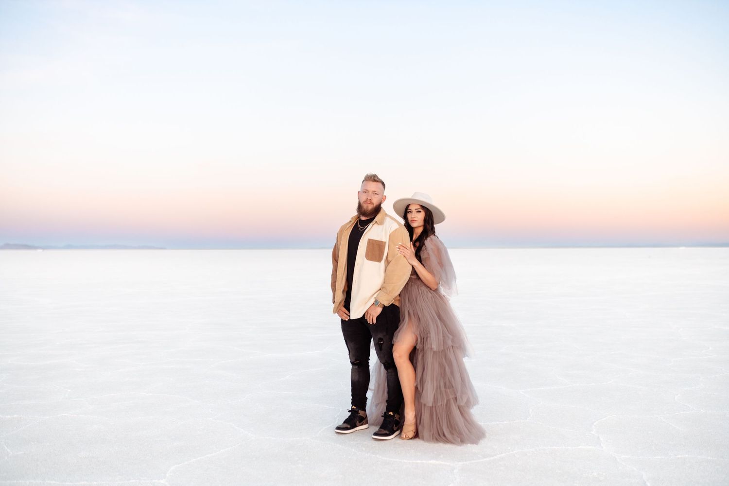 Couple hold each other during Salt Flats photos by Utah couples photographer during sunset
