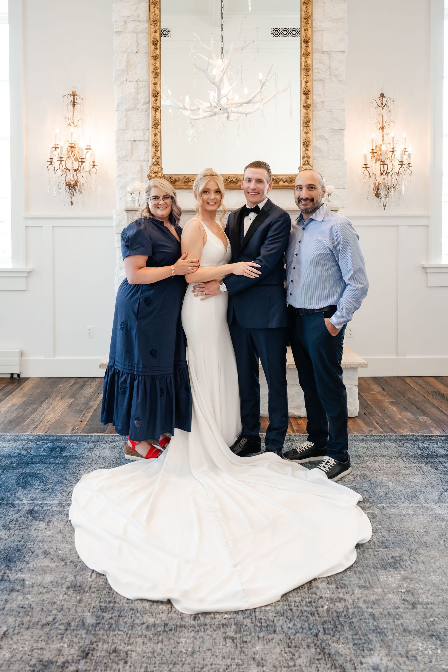 A sequence of candid wedding party photos in an elegant white room with chandeliers and blue carpeting.