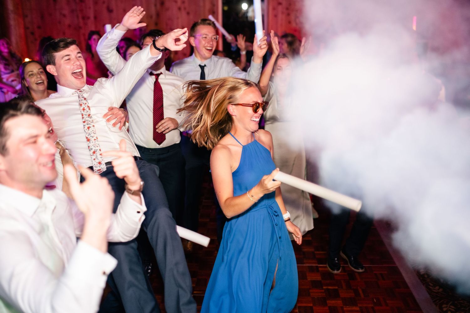 Wedding reception dance floor filled with fog machine effects and blue lighting.